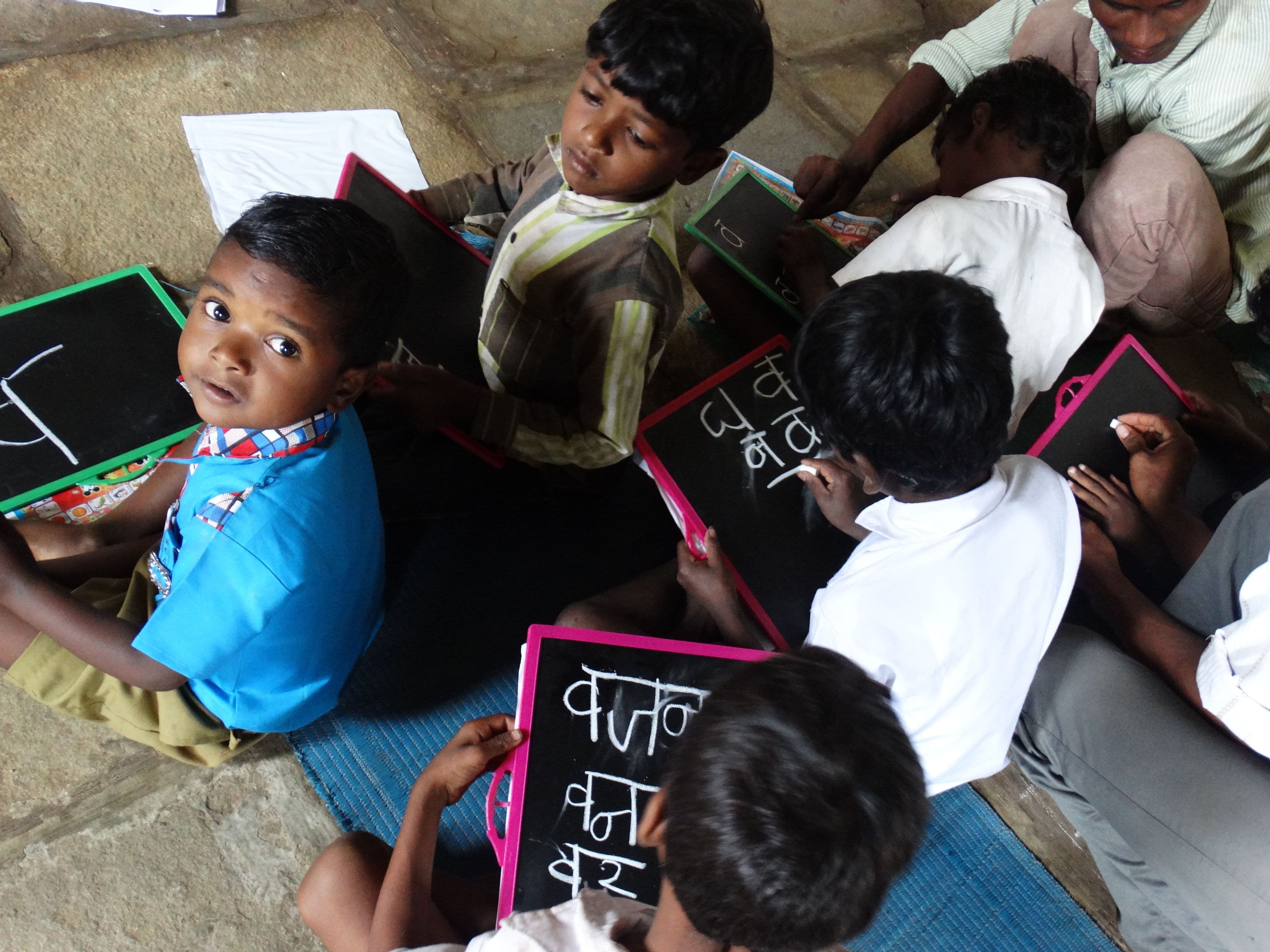 Students writing on slates during a learning session